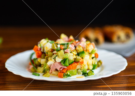 Homemade olivier salad with vegetables peas and mayonnaise 135903056