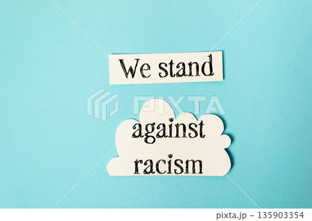 Blue background with a white cloud and the words We stand against racism Blue background with a white cloud and the words We stand against racism 135903354