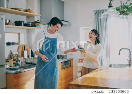 食器を片付ける夫婦 135903669