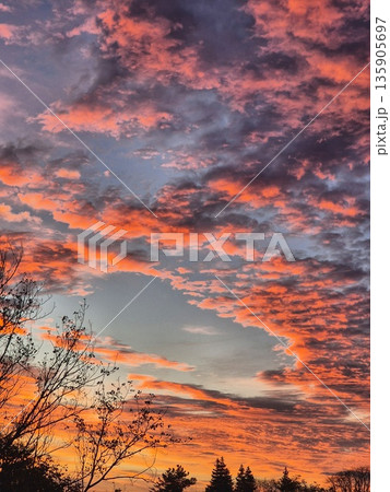 Dramatic Sunrise Clouds. Fiery Sky at Dawn. Orange and Blue Sky Panorama. Colorful Cloudscape Dramatic Sunrise Clouds. Fiery Sky at Dawn. Orange and Blue Sky Panorama. Colorful Cloudscape 135905697