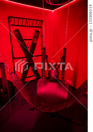 Sex swing in red light. BDSM equipment. Sex swing in red light. BDSM equipment. 135906514
