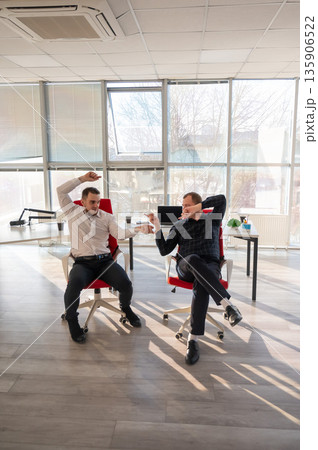 Two Caucasian men having fun at work. Two Caucasian men having fun at work. 135906522