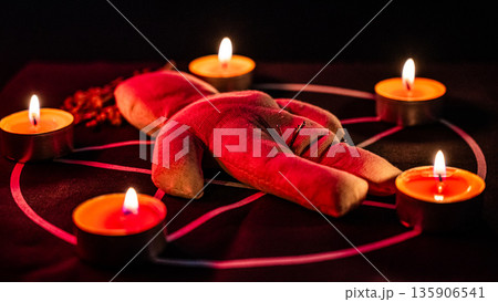 Voodoo doll on a pentagram. Witch spells. 135906541