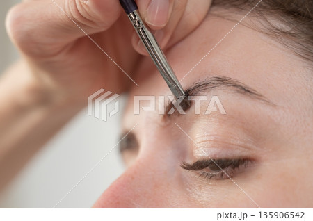 Caucasian woman getting eyebrow tinting procedure.  135906542
