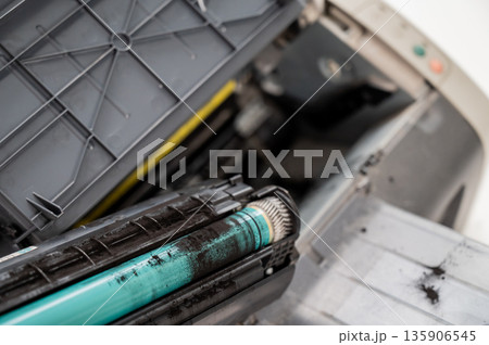 Broken laser printer cartridge on white background. Broken laser printer cartridge on white background. 135906545