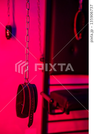 BDSM installation. Wall with chains and handcuffs. 135906737