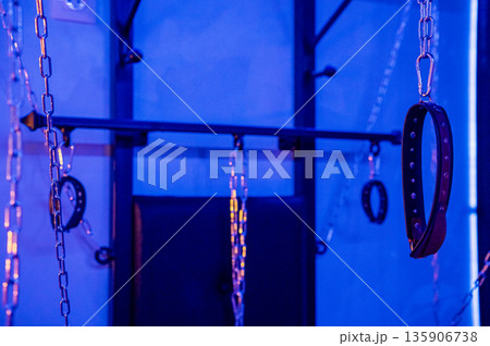 BDSM installation. Wall with chains and handcuffs. 135906738