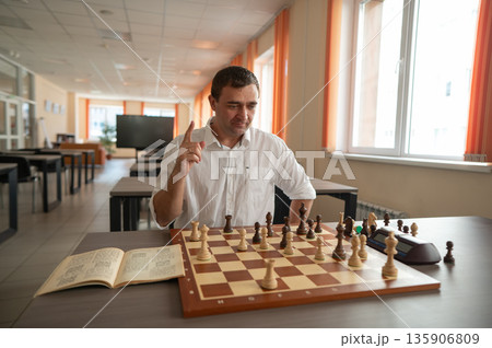 Middle aged Caucasian man playing chess. Middle aged Caucasian man playing chess. 135906809