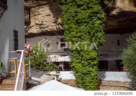 Unique whitewashed village built into dramatic rock formations, offers one of Andalusia most picturesque sights in Setenil de las Bodegas, Spain Unique whitewashed village built into dramatic rock formations, offers one of Andalusia most picturesque sights in Setenil de las Bodegas, Spain 135906899