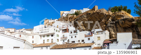 Unique whitewashed village built into dramatic rock formations, offers one of Andalusia most picturesque sights in Setenil de las Bodegas, Spain 135906901