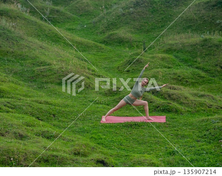 Caucasian woman doing yoga outdoors. Caucasian woman doing yoga outdoors. 135907214