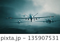 Drones flying in formation over a cloudy sky during a military exercise in the evening light 135907531
