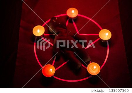 Voodoo doll on a pentagram. Witch spells. 135907560