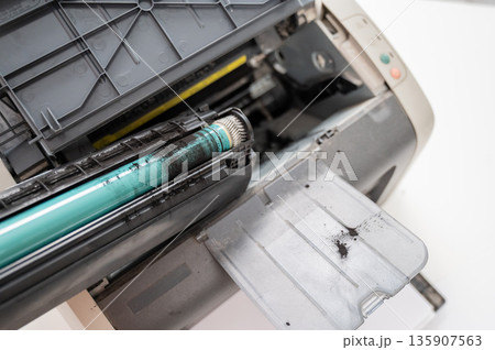 Broken laser printer cartridge on white background. Broken laser printer cartridge on white background. 135907563