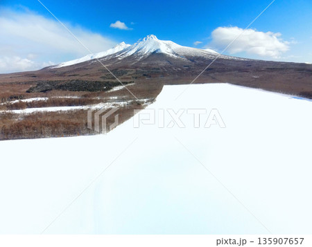 冬の北海道森町で雪原と駒ヶ岳の風景を空撮 冬の北海道森町で雪原と駒ヶ岳の風景を空撮 135907657