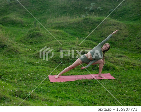 Caucasian woman doing yoga outdoors. Caucasian woman doing yoga outdoors. 135907773