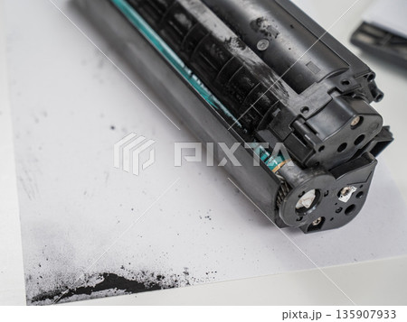 Broken laser printer cartridge on white background. Broken laser printer cartridge on white background. 135907933