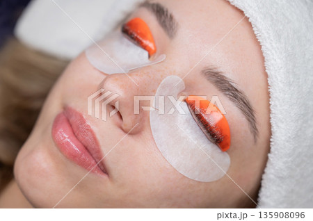 Caucasian woman undergoing eyelash lamination procedure.  135908096