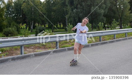 Caucasian woman rollerblading fast on road. Caucasian woman rollerblading fast on road. 135908396