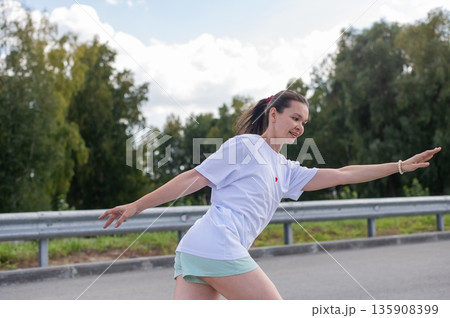 Caucasian woman in shorts roller skating.  135908399