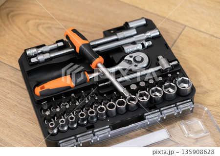 A well-organized professional tool kit featuring a variety of wrenches, sockets, and screwdriver bits for efficient home repairs and maintenance tasks A well-organized professional tool kit featuring a variety of wrenches, sockets, and screwdriver bits for efficient home repairs and maintenance tasks 135908628