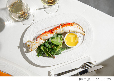 Crab leg with butter sauce and greens 135908869