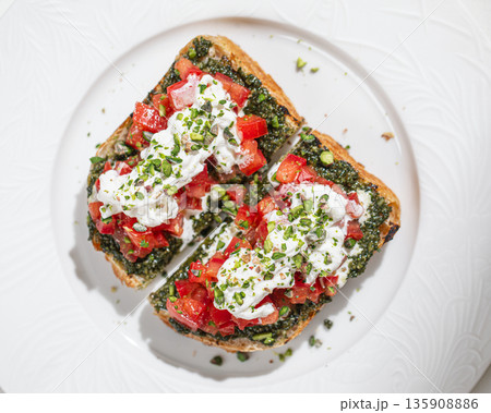 Bruschetta with pesto tomatoes and burrata 135908886