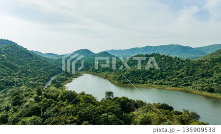 Kaeng Krachan dam with lake view and many green moutain, blue sky background. Kaeng Krachan Dam national park, Phetchaburi province, Thailand in aerial view from drone. Kaeng Krachan dam with lake view and many green moutain, blue sky background. Kaeng Krachan Dam national park, Phetchaburi province, Thailand in aerial view from drone. 135909538