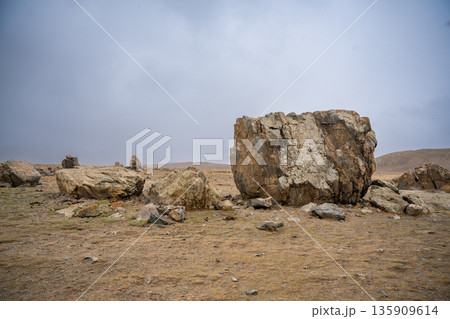 Ancient megalith near Kosh-Agach Altai Russia. Historic stone monument in remote Siberian mountain landscape. Place of power Ancient megalith near Kosh-Agach Altai Russia. Historic stone monument in remote Siberian mountain landscape. Place of power 135909614
