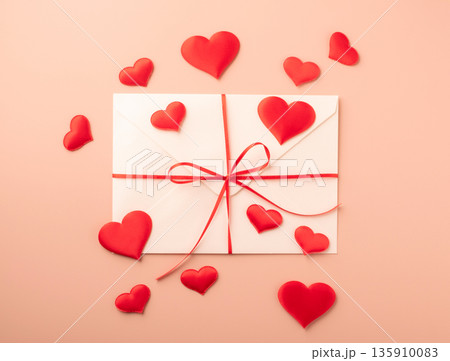 Love letter envelope with red hearts and ribbon Love letter envelope with red hearts and ribbon 135910083