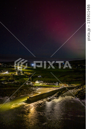 The Aurora Borealis, the northern lights, showing up above Portnoo harbour in County Donegal, Ireland 135911486