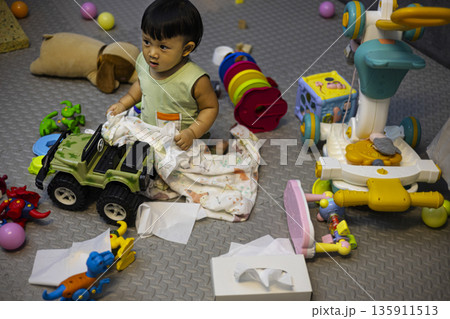 Toddlers Playing In A Very Messy Living Room, A chaotic of toddlers playing in living room, toys scattered everywhere with laughter in bright chaos, family life or playful mess documentary. Toddlers Playing In A Very Messy Living Room, A chaotic of toddlers playing in living room, toys scattered everywhere with laughter in bright chaos, family life or playful mess documentary. 135911513