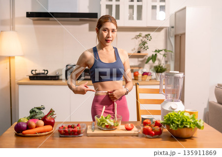 Fit woman enjoys healthy fruit breakfast after yoga training. fitness, nutrition, healthy lifestyle. 135911869