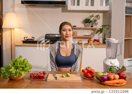 Fit woman enjoys healthy fruit breakfast after yoga training, fitness, looking to camera. Fit woman enjoys healthy fruit breakfast after yoga training, fitness, looking to camera. 135911896
