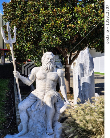 Neptune or Poseidon sculpture holding a trident. 135912507