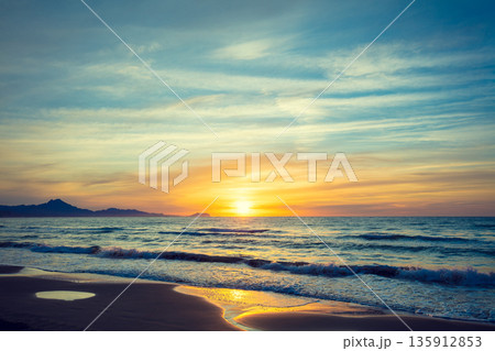 Seascape in early morning during a beautiful purple sunrise. San Juan beach, Alicante, Spain, Europe Seascape in early morning during a beautiful purple sunrise. San Juan beach, Alicante, Spain, Europe 135912853