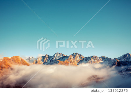Mountains minimalist landscape. Peaks of the mountains above the clouds. Pyrenees, Andorra, Europe Mountains minimalist landscape. Peaks of the mountains above the clouds. Pyrenees, Andorra, Europe 135912876