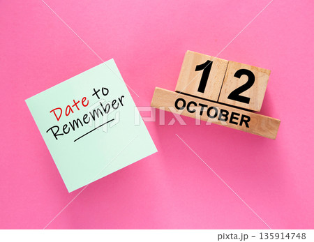 Date October 12 to remember concept with sticky note and wooden calendar 135914748
