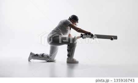 Female cricket player kneeling and playing defensive shot. 135916743