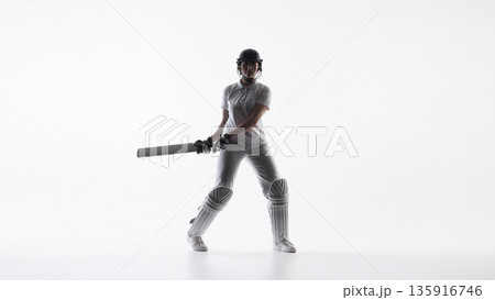 Cricket player holding bat in ready stance in studio. 135916746