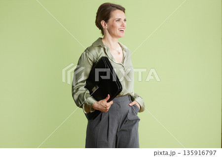 Smiling businesswoman with briefcase Smiling businesswoman with briefcase 135916797