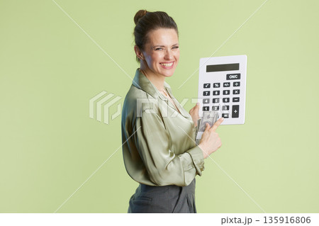 Woman with Calculator and Currency: Financial Focus. 135916806