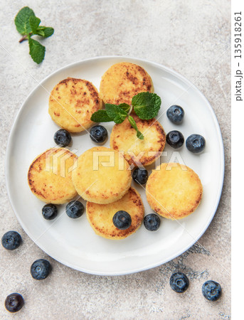 Homemade syrniki cottage cheese pancakes with blueberries and mint 135918261