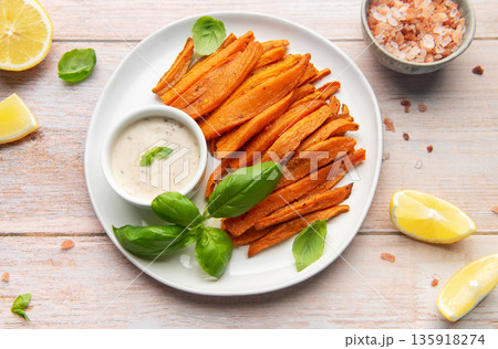 Sweet potato fries with dipping sauce and fresh basil Sweet potato fries with dipping sauce and fresh basil 135918274