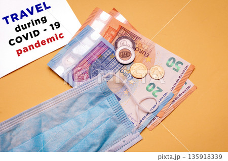 Euro bank notes with face mask Euro bank notes with face mask 135918339