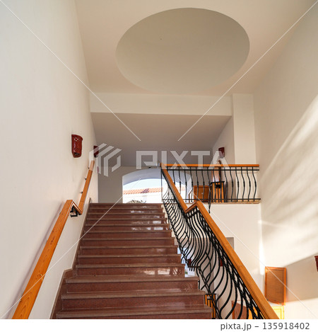 Stairs to the top of a house with white walls and a ceiling Stairs to the top of a house with white walls and a ceiling 135918402