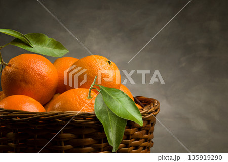 Orange fruits in a wicker basket 135919290