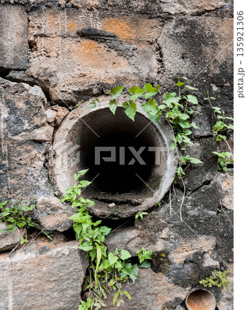 Large Drainage Pipe in a cement wall  135921306