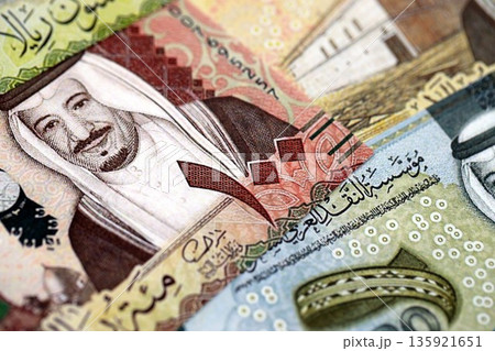 Saudi Arabia riyal money bills banknotes lies in big pile on table close up. Concept of finances and business in Saudi Arabia Saudi Arabia riyal money bills banknotes lies in big pile on table close up. Concept of finances and business in Saudi Arabia 135921651