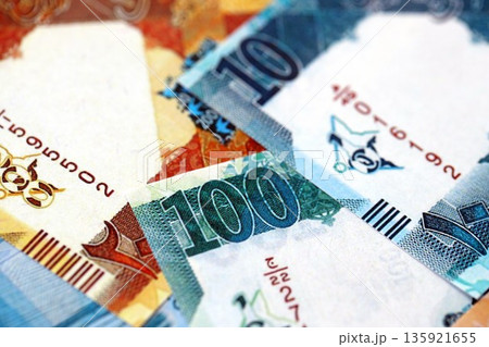 Qatari riyal money bills banknotes lies in big pile on table close up. Concept of finances and business in Qatar Qatari riyal money bills banknotes lies in big pile on table close up. Concept of finances and business in Qatar 135921655